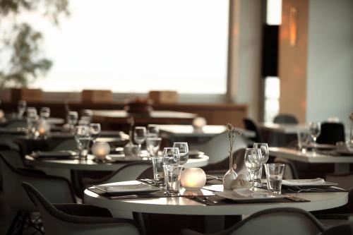 a group of tables with wine glasses and napkins at Sikyon Coast Hotel And Resort in Xylokastron