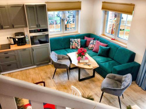 a living room with a blue couch and a table at Domek na Siglanach in Wisła