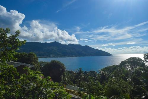 a view of a large body of water with mountains at Sunset Bay Apartment in Glacis