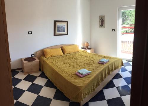 a bedroom with a bed and a checkered floor at Lipovac resort Ficus in Bilice