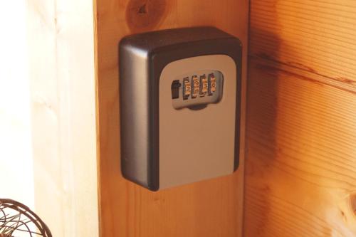 a soap dispenser attached to a wooden wall at Ferienwohnung im gemütlichen Blockhaus vor den Bergen in Wielenbach