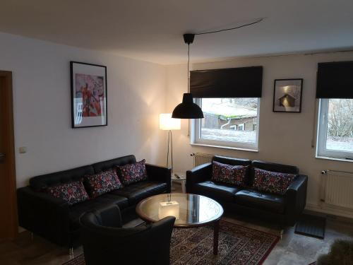 a living room with a couch and a table at Jonas Apartment in Winterberg