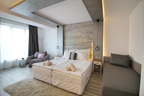 a bedroom with a large white bed in a room at Ice Jewel Chalet, Bansko, 200 meters from the Gondola, 20 улица „Свети Иван Рилски“ in Bansko