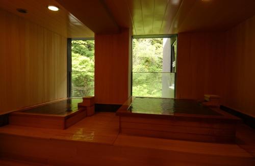 a room with two jacuzzis and a window at Harataki in Aizuwakamatsu