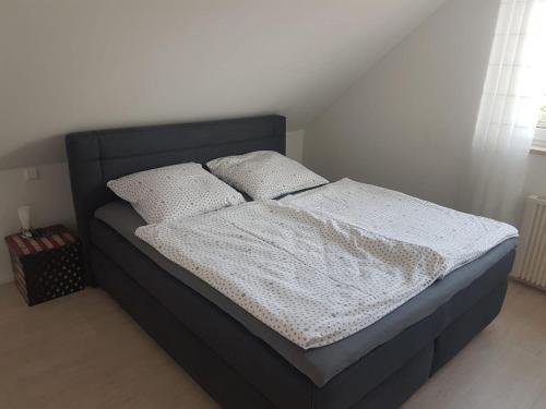 een bed met twee kussens in een slaapkamer bij 50 Quadratmeter abgeschlossene Wohnung mit Panoramablick in Pfaffenhofen an der Ilm