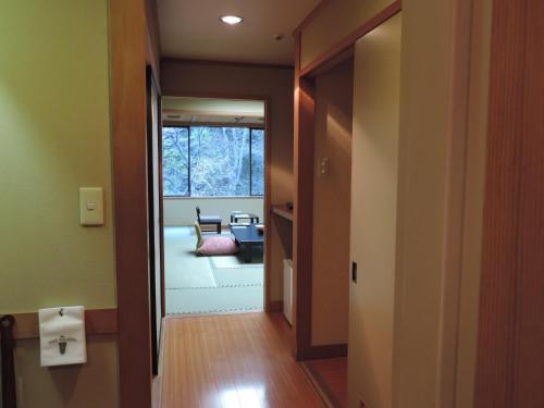 a hallway with a door open to a living room at Harataki in Aizuwakamatsu