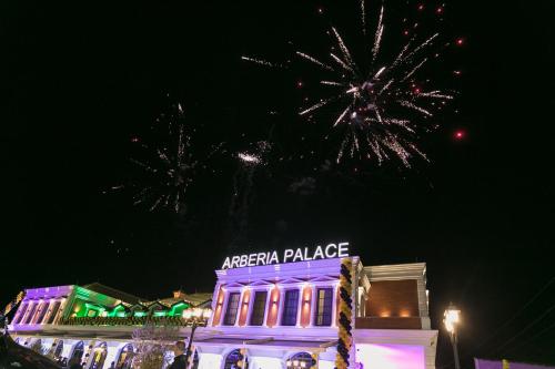 a building with fireworks exploding in the sky at Arberia Palace Hotel in Fushë-Milot