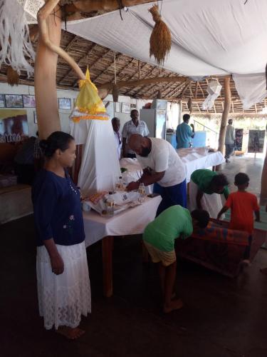 a group of people standing around a table at The Alpha Monkey hotel & Tree house in Tangalle