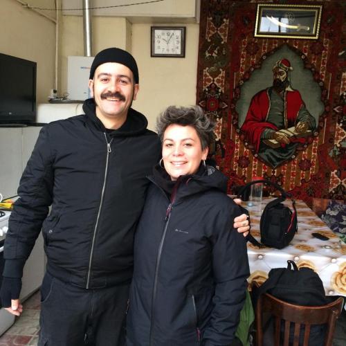 a man and a woman standing in front of a table at Huseyn Houses in Ganja