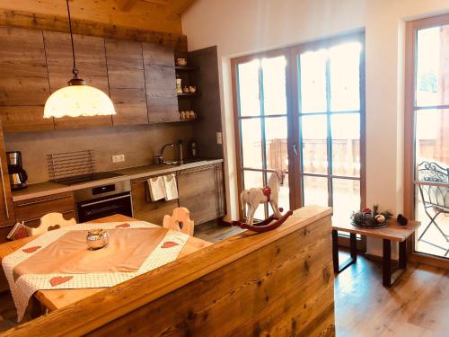 a kitchen with a wooden table in a room at Bergidyll an der Lane - Pfunders in Fundres