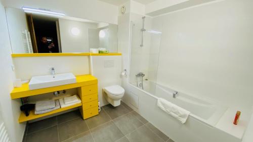 a bathroom with a sink and a toilet and a shower at Hôtel Villa Blomet in Paris