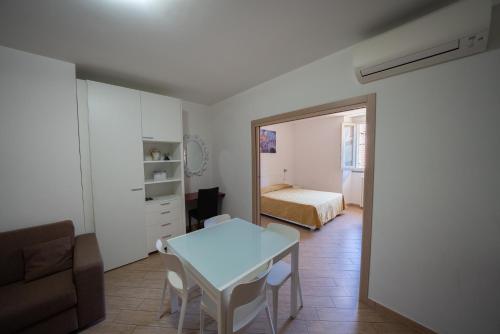 a living room with a table and a bedroom at Residence SANTABBONDIO in Como