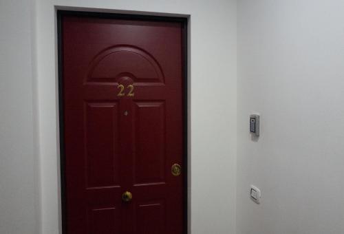 a red door with the number on it at Residence SANTABBONDIO in Como