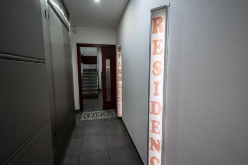 a hallway leading to a room with a mirror at Residence SANTABBONDIO in Como