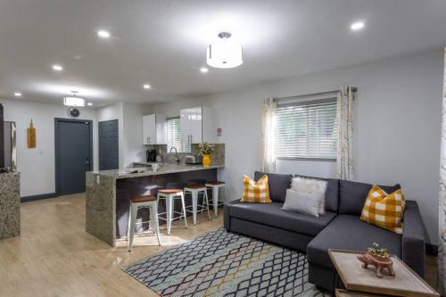 a living room with a couch and a kitchen at Casa Madeira @ the heart of Miami Design District in Miami