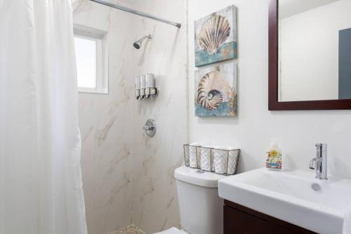 a bathroom with a shower and a toilet and a sink at Casa Madeira @ the heart of Miami Design District in Miami