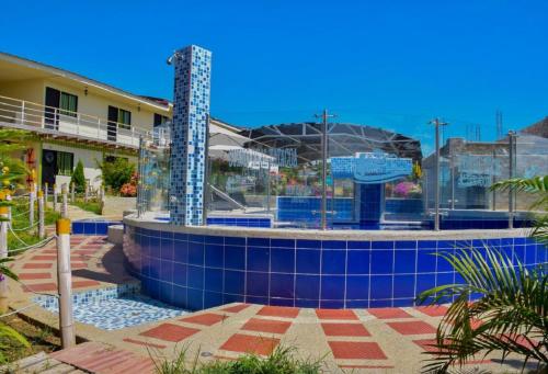 a swimming pool with a building in the background at HV Sueño Real Tatacoa in Villavieja