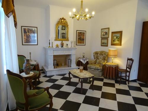a living room with a fireplace and a table and chairs at Villa ADA in Hydra