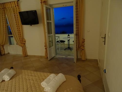 a bedroom with a bed and a view of the ocean at Villa ADA in Hydra