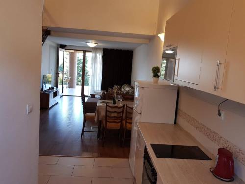 a kitchen and dining room with a table and a refrigerator at Apartment Dasic in Bar