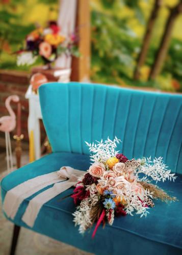 a bouquet of flowers sitting on a blue bench at Villa Botanica in Mirkovec