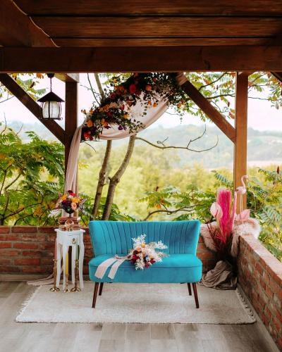 a blue couch sitting on a porch with a view at Villa Botanica in Mirkovec