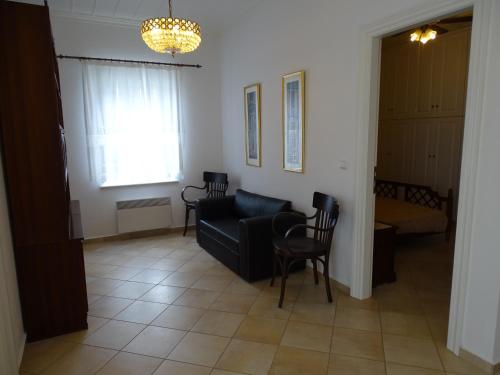 a living room with a black couch and chairs at Villa ADA in Hydra