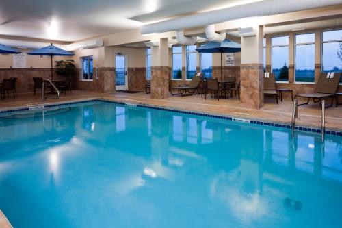 a large swimming pool with tables and chairs at Holiday Inn Express Washington Court House, an IHG Hotel in Washington Court House