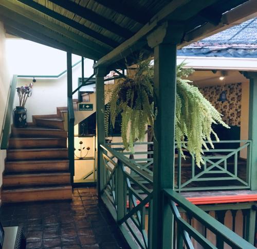 a hallway of a house with a green fence at Hotel Posada de San Agustin in Tunja