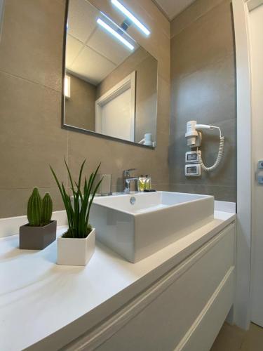 a bathroom with a white sink and a mirror at BeeApartments in Bari