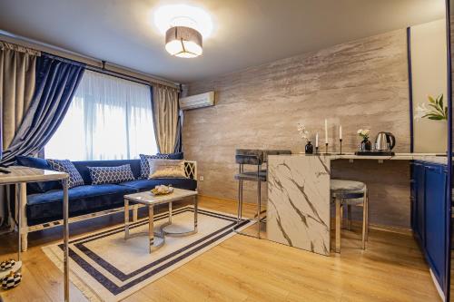 a living room with a blue couch and a table at Lord Morgan & Exclusive Design Residence Nişantaşı in Istanbul