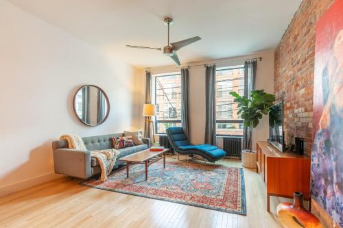 a living room with a couch and a tv at Gorgeous Park House w Parking on Queen West in Toronto