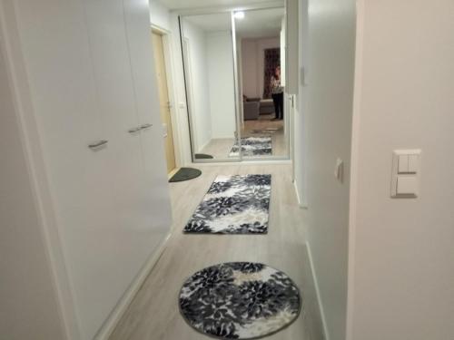 a hallway with two rugs on the floor of a room at Upea kaksio, Keskustorin laidalla in Seinäjoki