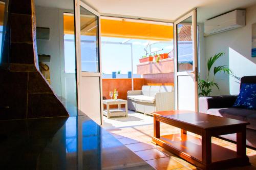 a living room with a couch and a table at Casa Tigot in Puerto del Carmen