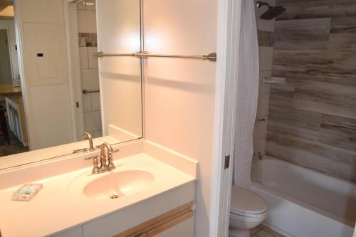 a bathroom with a sink and a shower and a toilet at Maui Banyan G310B in Wailea