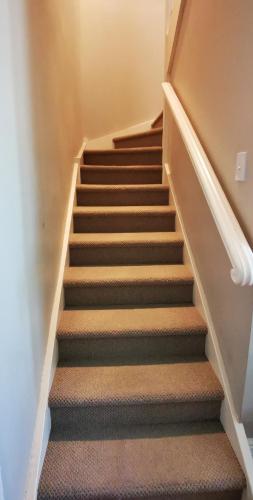 a staircase in a home with a stair case at Regent Residential Villa in Whangarei