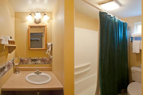 a bathroom with a sink and a shower at Casablanca Motel in Manchester