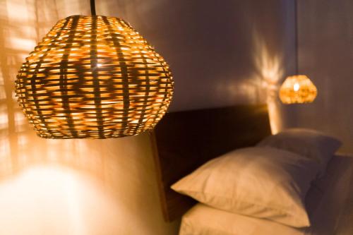 a room with a lamp and a bed with a pillow at Casa Beu in Puerto Escondido