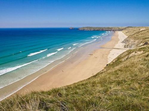 a view of a beach with the ocean at Surf's Up in Perranporth, Cornwall Coastal Holidays in Perranporth
