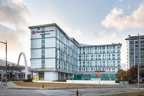 a large white building with a sign on it at Best Western Premier Incheon Airport Hotel in Incheon