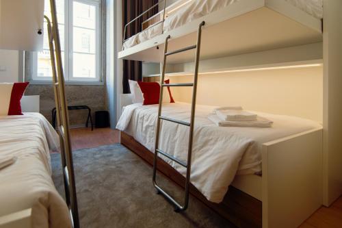 a bedroom with two bunk beds with red pillows at HI Braga - Pousada de Juventude in Braga