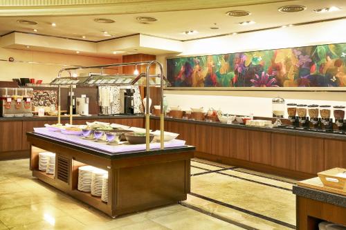 Un restaurante con un mostrador con platos encima. en Best Western Premier Incheon Airport Hotel, en Incheon