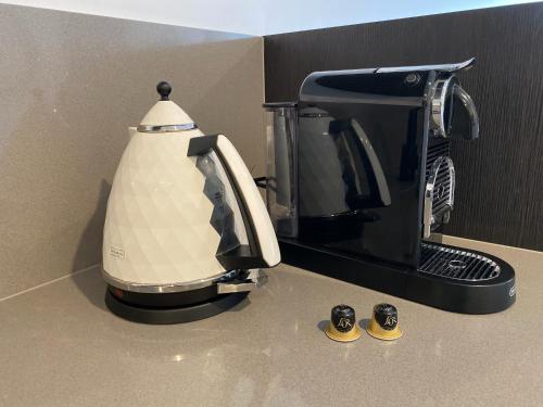 a coffee maker sitting on top of a counter at Midnight Luxe 1BR 1Bath Apartment 104 in the heart of Braddon Pool Sauna Secure Parking Wine WiFi in Canberra