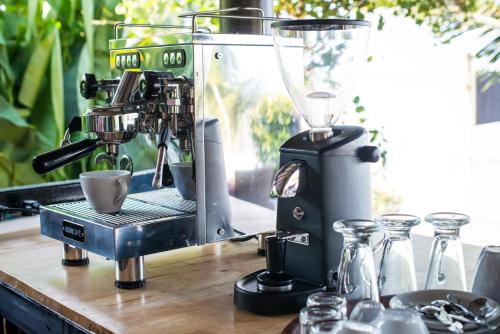 a coffee maker sitting on top of a wooden counter with a coffee maker at Serenity Resort Koh Chang in Ko Chang