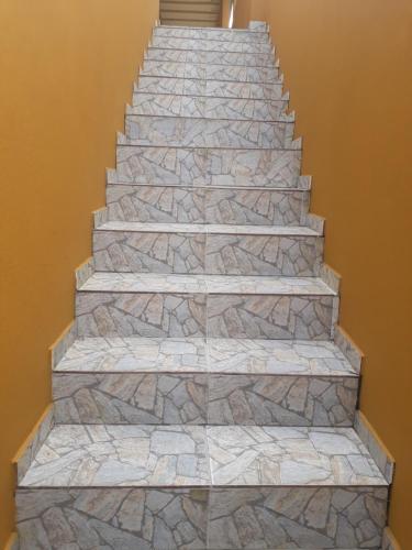 a stone staircase in a home with a stone floor at Hospedagem da Rose in Marataizes
