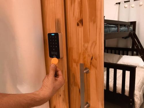 a person opening a door with a remote control at Imagina Hostel in Sao Paulo