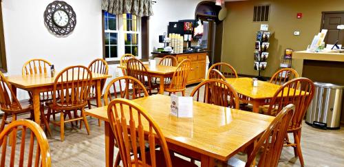 a dining room with wooden tables and chairs at Lodging on the Square in Berlin