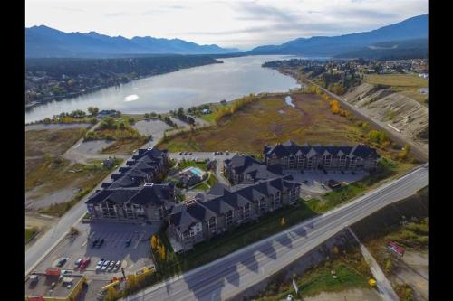 an aerial view of a house next to a river at Modern Cozy 2 Bed 2 Bath with Lake and Mountain Views Pool and Hot Tub in Invermere