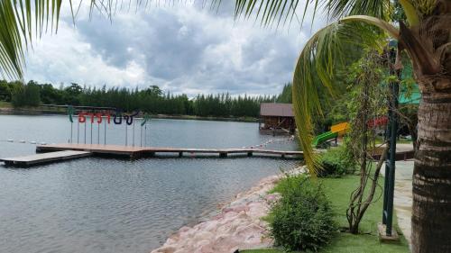 a dock in the middle of a body of water at Tara Beach Resort Udonthani in Udon Thani