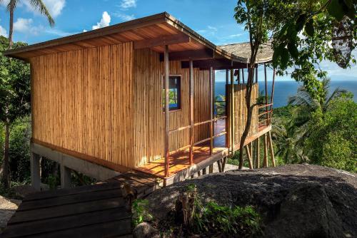 a small wooden building on top of a rock at Ecotao Lodge in Koh Tao